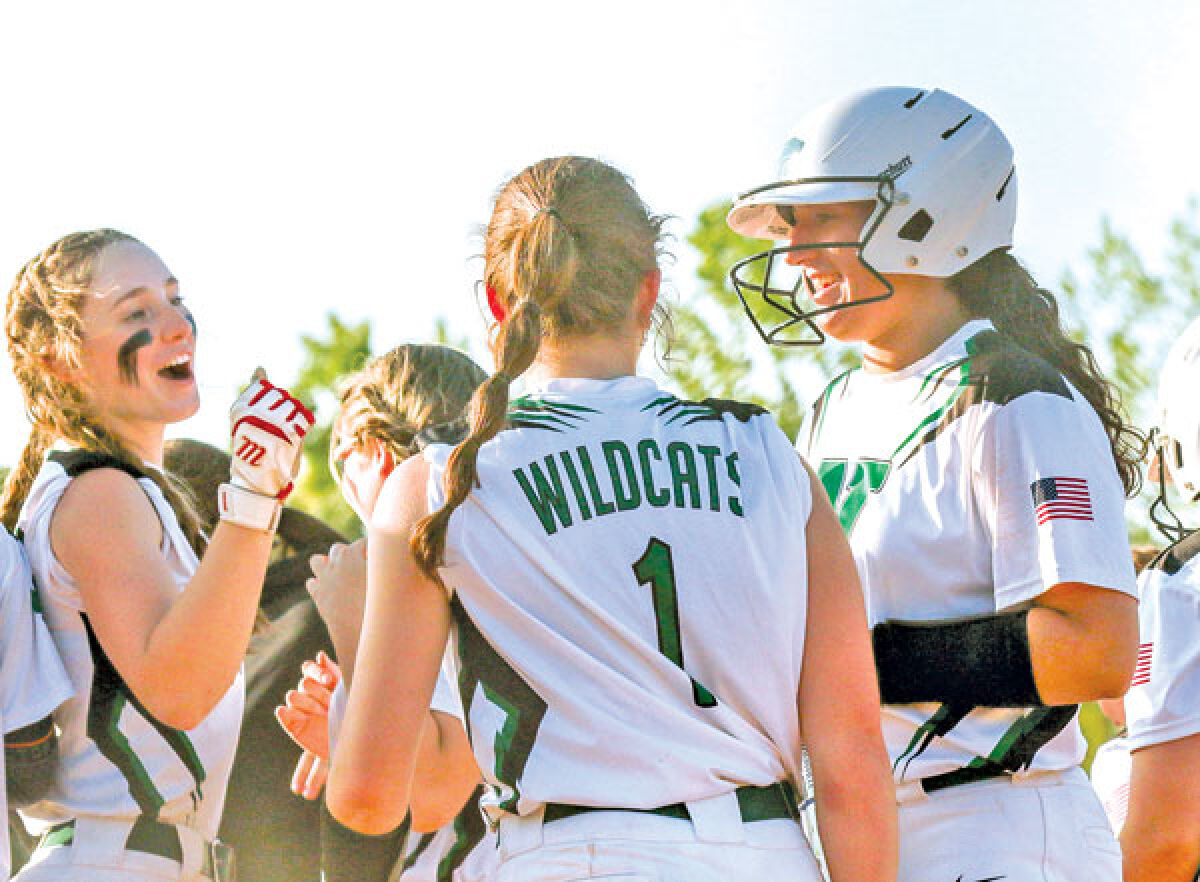  At right, Novi senior Reganne Bennett, a University of South Carolina commit, celebrates with her teammates after a home run during a regular season game against West Bloomfield High School May 15 at Novi High School. 