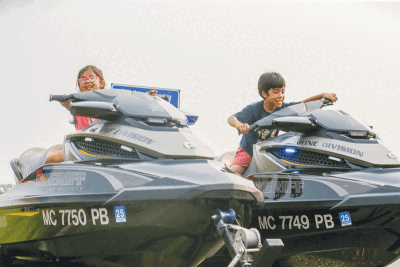  Omar Cortex, 8, and Isabella Cortex, 6, both of Clinton Township, check out the Macomb County Sheriff’s Office Marine Division jet skis at the National Night Out event on Aug. 1. 