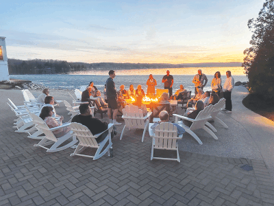  Guests gather around a campfire to take in the sunset overlooking Walloon Lake. 