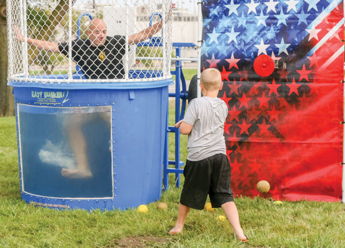  A community member takes a shot at dunking a member of the Macomb County Sheriff’s Office Dive Team at National Night Out Aug. 1. 