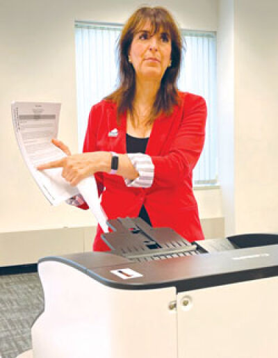  Oakland County Clerk Lisa Brown demonstrates how absentee ballots are tested to ensure there are no inaccuracies or problems reading ballots prior to Election Day. 