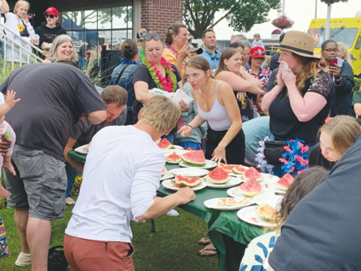  People chow down on watermelon as they participate in Aqua Fest’s 24th Annual Watermelon Eating Contest. 