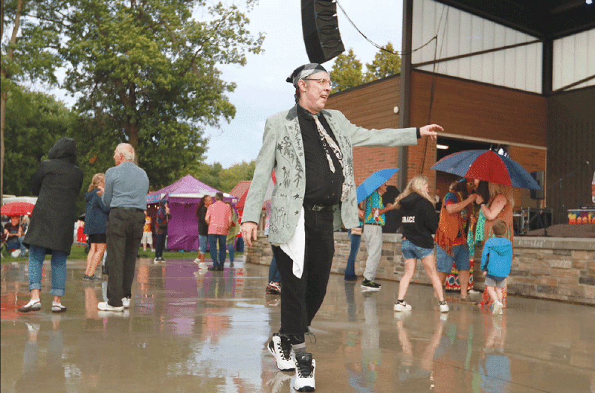  Brian Alsobrooks, also known  as Spaghetti Man, dances to  the Magic Bus band performing at Dodge Park Aug. 17.  