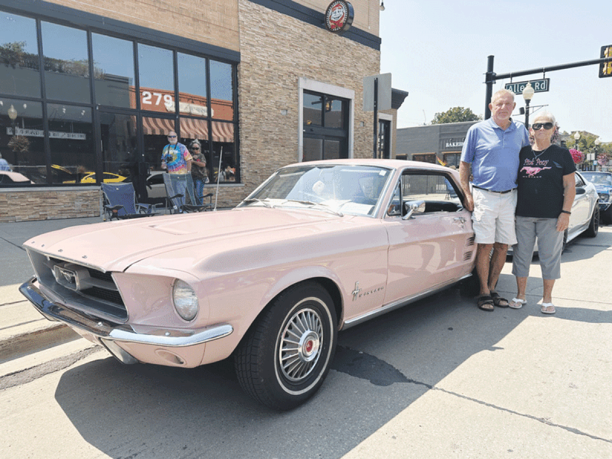  Pam and Mike Compson show off their dusk rose 1967 Ford Mustang in Mustang Alley at the Woodward Dream Cruise in Ferndale Aug. 19. 
