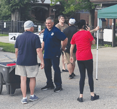  Grosse Pointe Park City Council candidate Kirk Merametdjian talks to voters at Windmill Pointe Park during the primary election Aug. 8. 