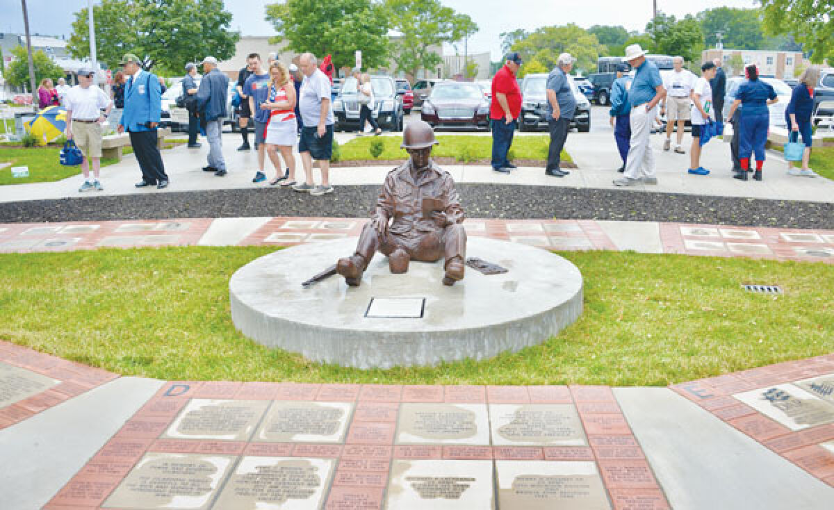  The figure of “Joe” from the sculpture “Mail Call,” by Larry Halbert, sits in the middle of the Michigan World War II Legacy Memorial. 