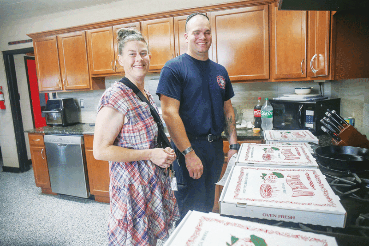  Melissa Albers visits the paramedics at the Hazel Park Fire Department Aug. 24. She brought them dinner from Nick’s Pizza in Ferndale, thanking them for saving her after she was pierced by a fallen tree branch in July.  