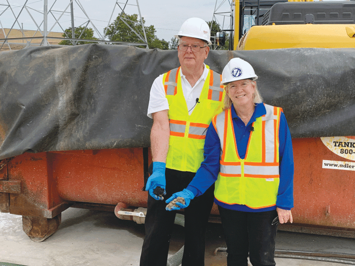  Macomb County Public Works Commissioner Candice S. Miller and Macomb County Commissioner Don VanSyckel examine handfuls of sediment removed from the Macomb Interceptor Drain. 