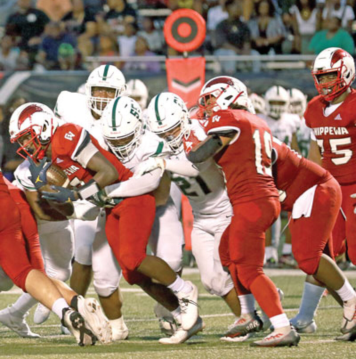  West Bloomfield’s defense teams up to make the tackle on a Chippewa Valley ball carrier. 