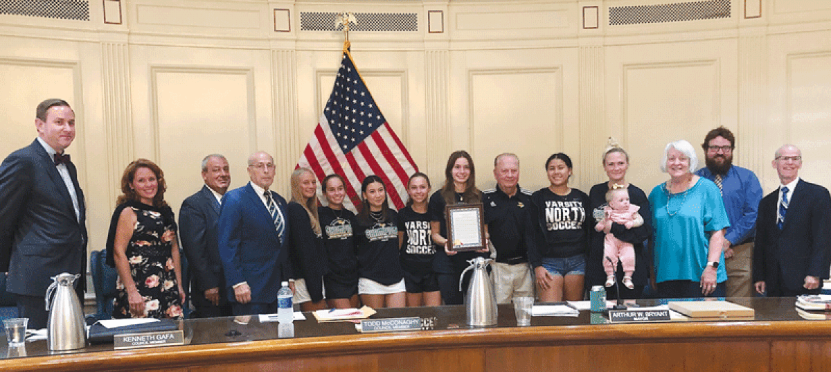  Photo by K. Michelle Moran The Grosse Pointe North High School girls soccer team and coaching staff are congratulated for their state championship by Grosse Pointe Woods Mayor Arthur Bryant and the Woods City Council Aug. 7. 