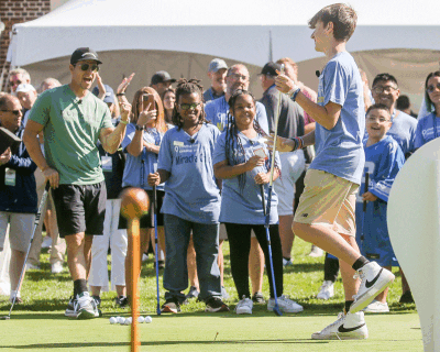  Connor Barringer, the 2023 Miracle Ambassador for Beaumont Children’s, sinks a putt during a putting challenge at the invitational. 