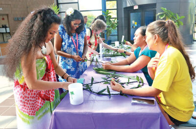  Participants in the Luau for Lahaina make leis after donating money to help the victims of the wildfires. 
