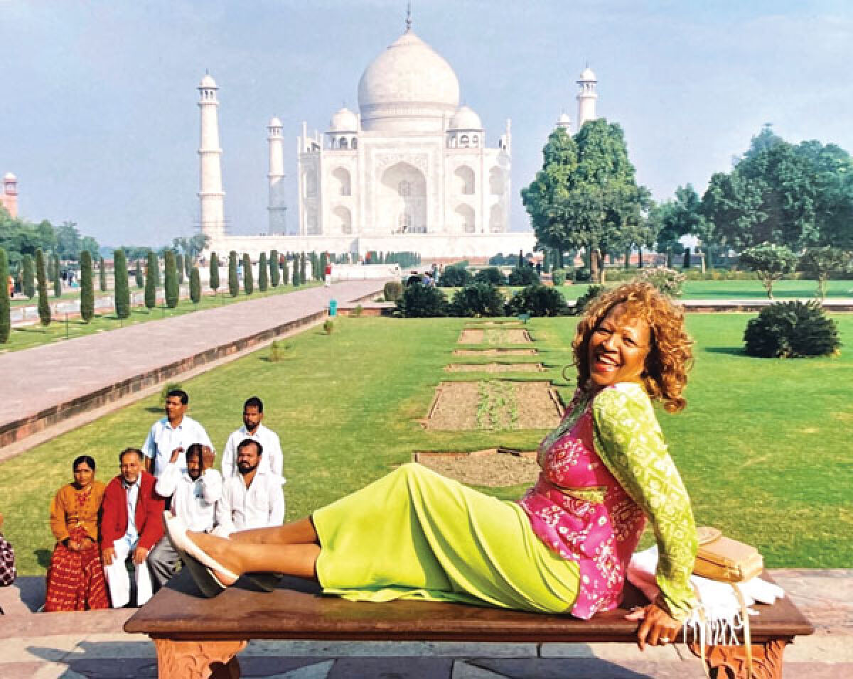 Loretta DeLoach poses by the Taj Mahal during one of her Goodwill Santa Tours. 