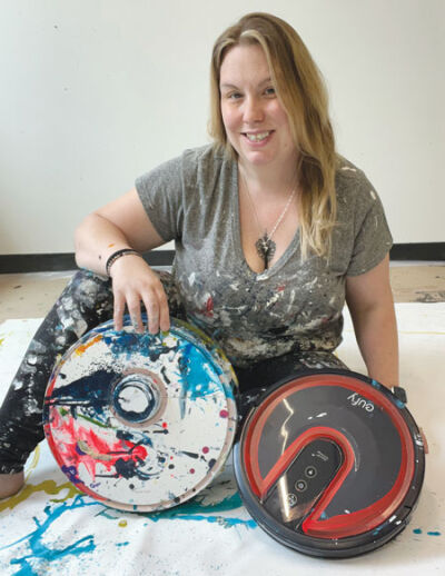  Amanda Koss uses two vacuum robots: “Betty,” left, and one that is unnamed. The robots contributed to the creation of several art pieces that will be on display at ArtPrize in Grand Rapids from Sept. 14 to Oct. 1.  