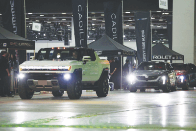  Electric vehicles line up to take auto show attendees on  rides at the Powering Michigan EV Experience. 