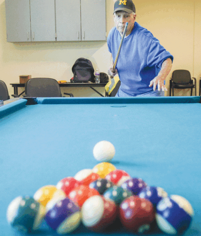  Jerry Agents plays pool in the billiards room. The new Active Adult Center features many separate spaces that will allow for different activities.  