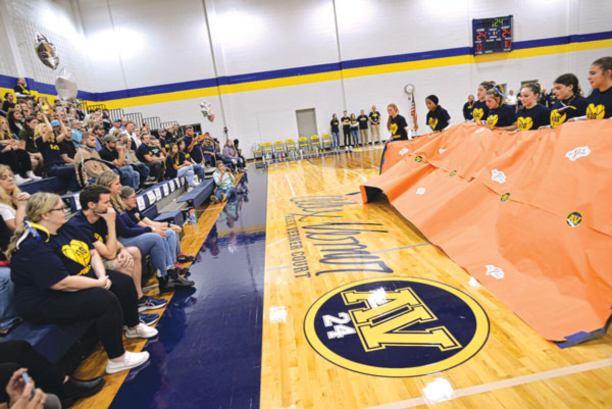  Members of the Clawson High School volleyball team unveil the Alex Verner Court on Sept. 14.  