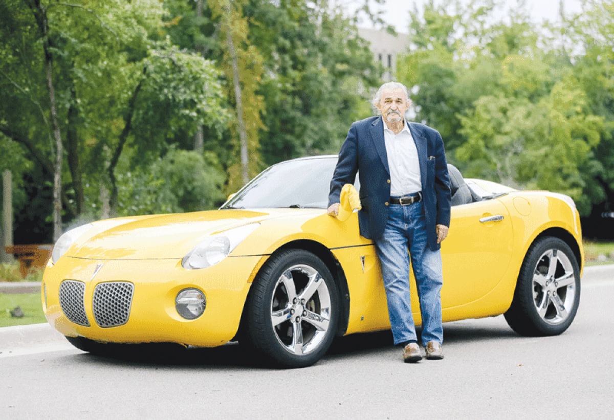  Seymour Markowitz, of West Bloomfield, here with his yellow  2009 Pontiac Solstice, has owned  convertibles since he was a teenager.  
