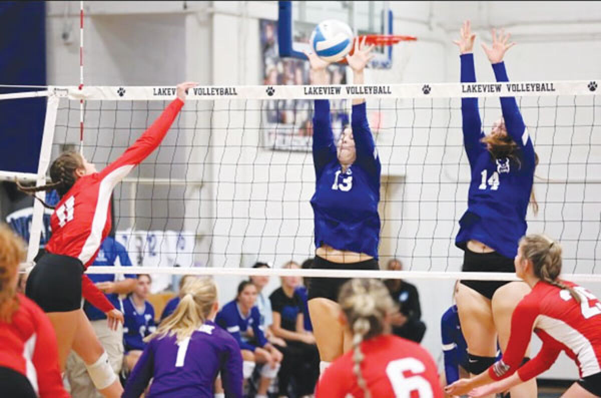  Lakeview seniors Alexis Pouttu and Autumn Wirick go up for a block during a game. 