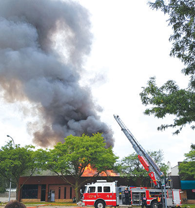  St. Clair Shores Fire Chief James Piper said two ladder trucks doused the fire with water from above as the flames burned through the roof of a five-unit strip mall in the 23000 block of Harper Avenue near Nine Mile Road Sept. 10. 