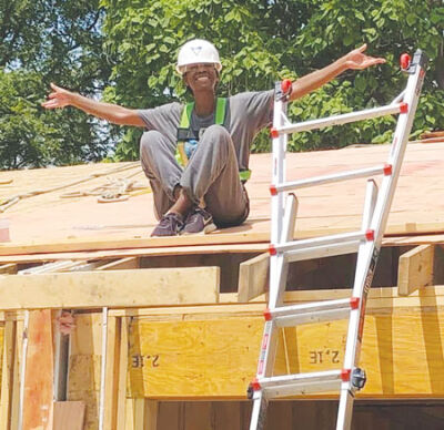  Carla Strickland, a member of Habitat for Humanity’s local Women Build Team, helps complete a roof at one of the homes they build for families in need. 