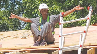  Carla Strickland, a member of Habitat for Humanity’s local Women Build Team, helps complete a roof at one of the homes they build for families in need. 