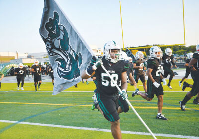  West Bloomfield runs onto the field before their matchup against Rochester Adams. 