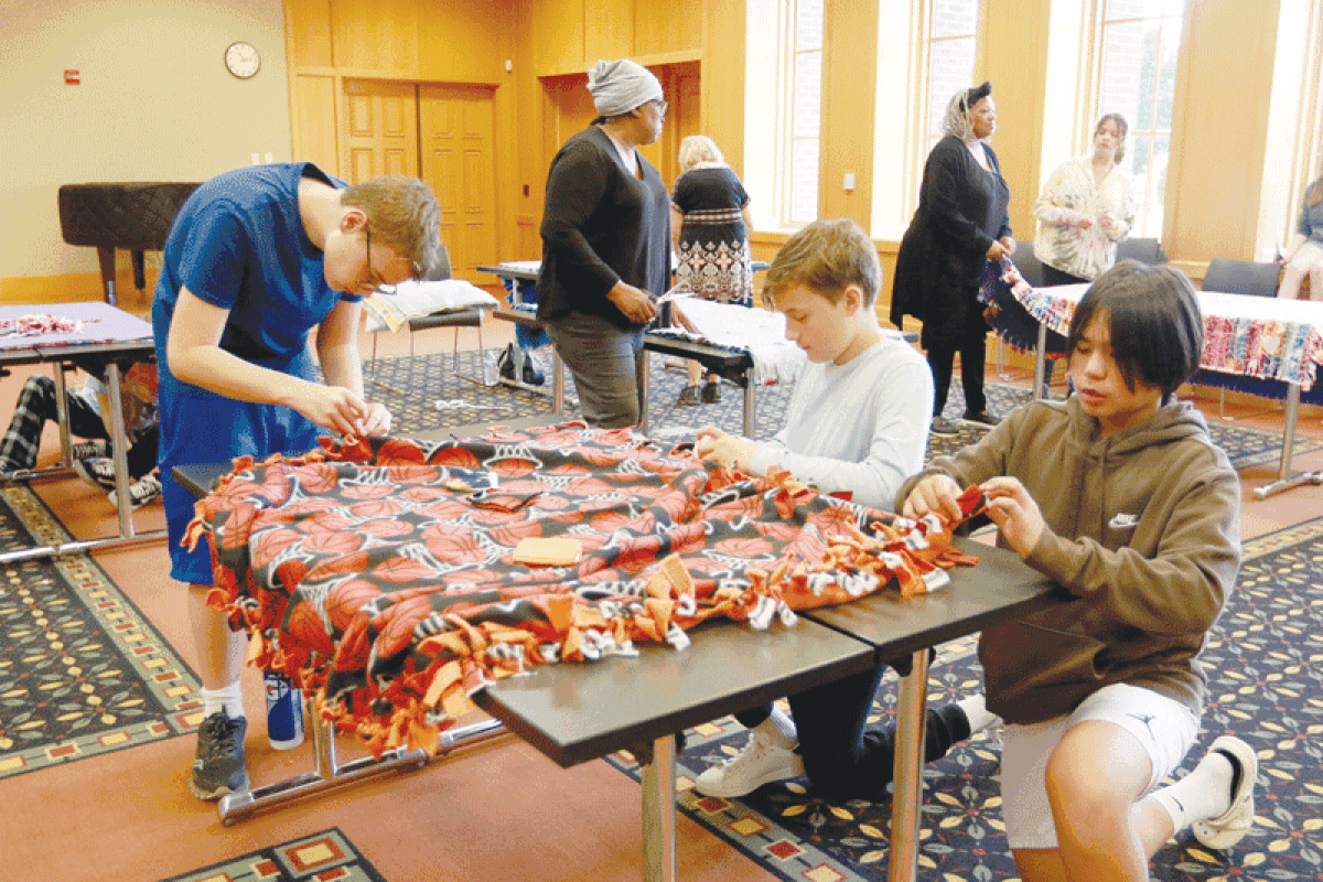  Wyandot Middle School National Junior Honor Society students Edward Smith, left, Grady Dobner and  Matthew Moran help make blankets for Team Patton Outreach on Sept. 16. The blankets will be donated to several hospitals and medical centers in memory of Erin Terina Maria Patton. 