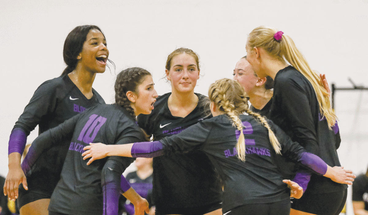  Bloomfield Hills circles up on the court after scoring a point. 