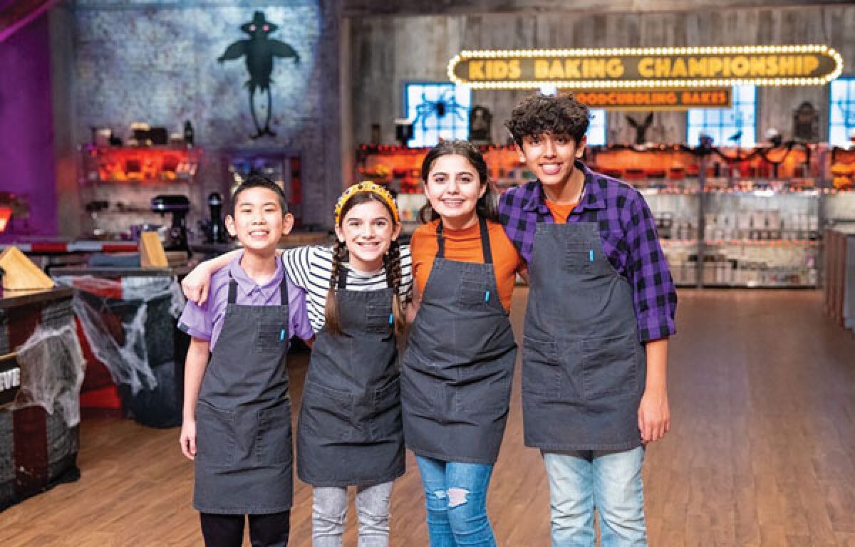  Eleven-year-old Troy resident Genevieve Kashat, pictured, second from right, won among three other veterans of Food Network’s “Kids Baking Championship” in a Halloween-themed baking special. 
