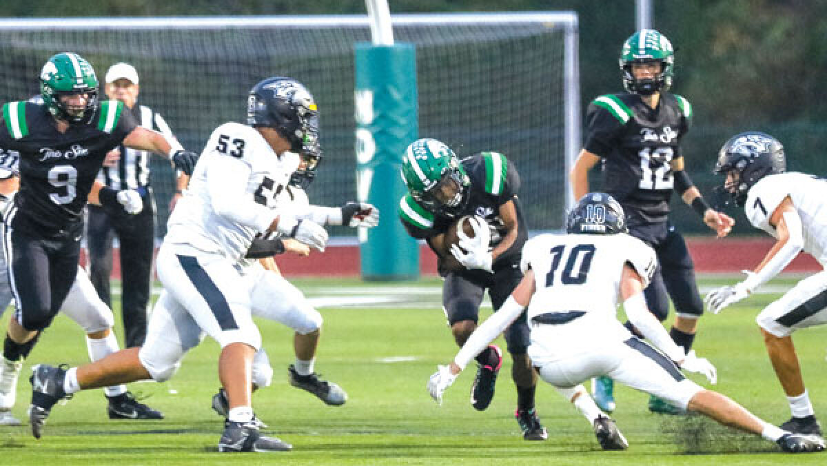  Novi running back Logan Ellison lowers his shoulder to the Plymouth defense during Novi’s 48-45 win over Plymouth Sept. 29 at Novi High School. 