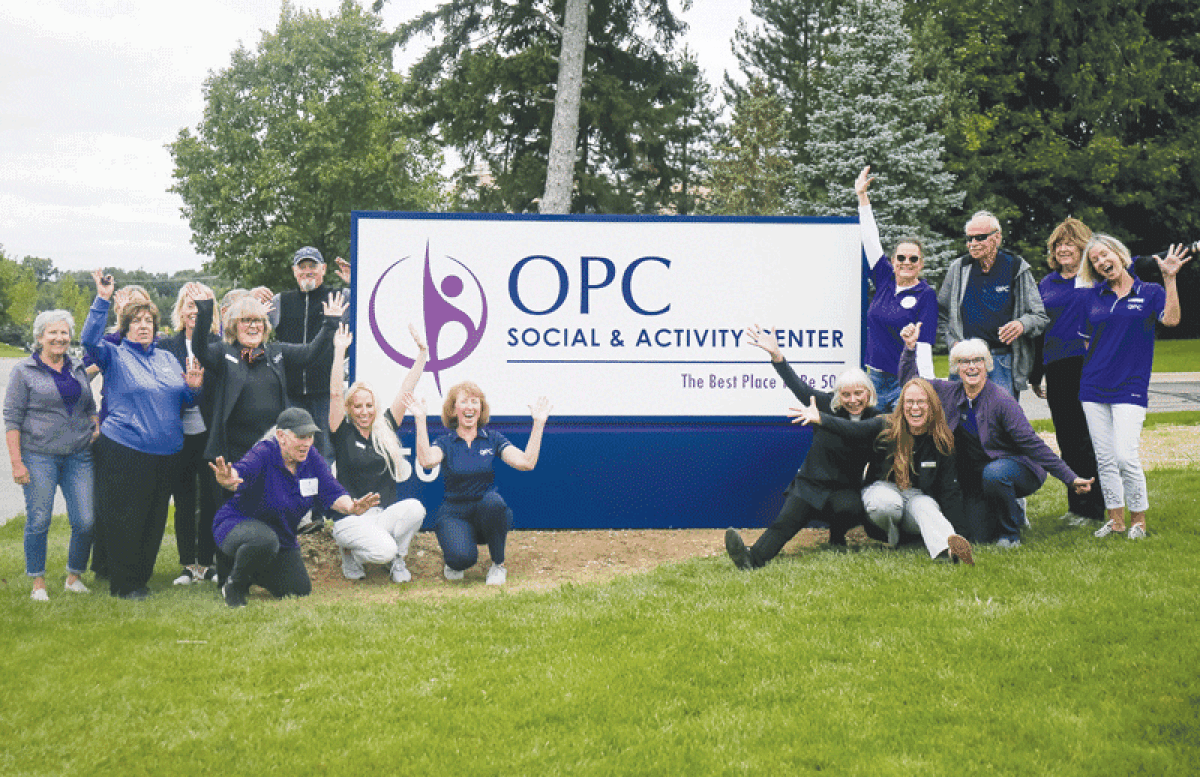  OPC Social and Activity Center staff pose in front of the new sign on Letica.  