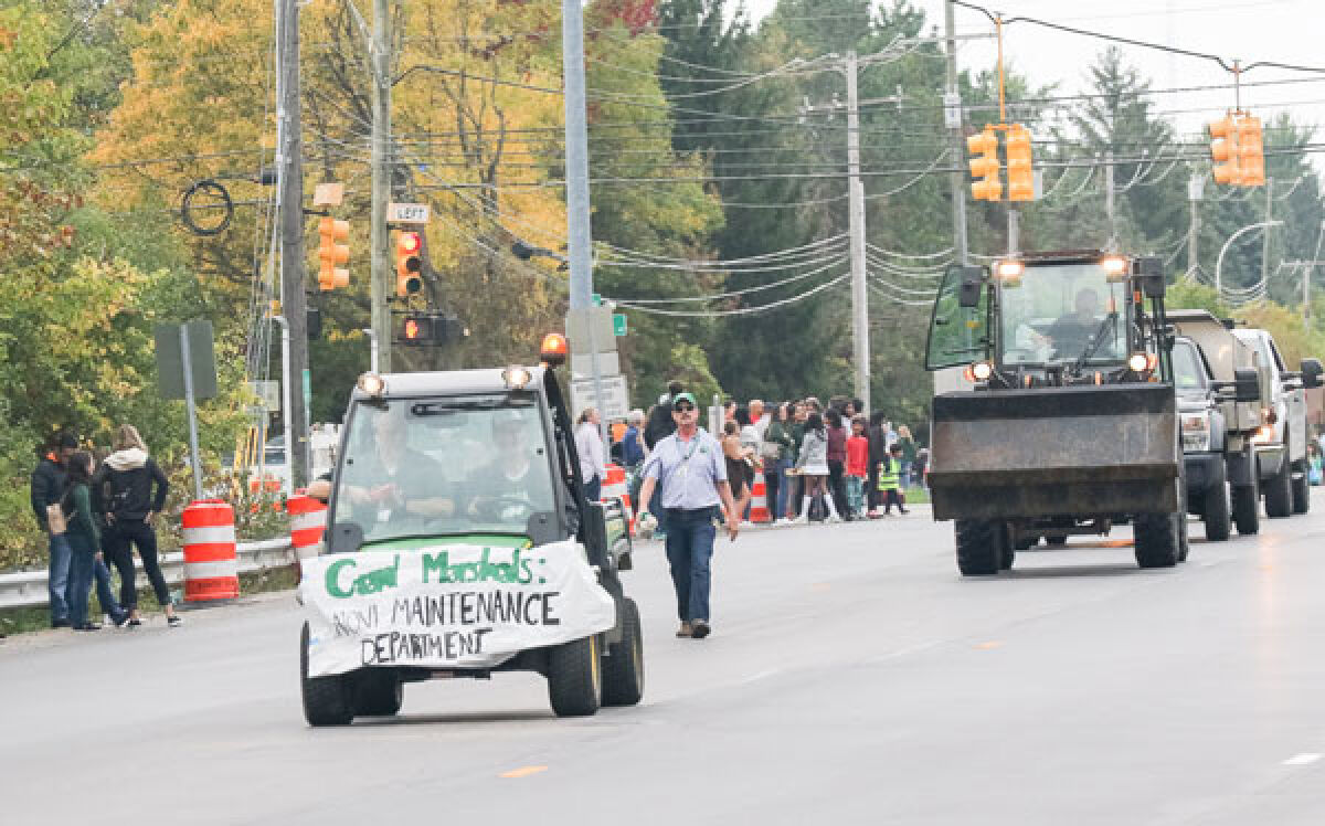  As the grand marshals of the Novi High School homecoming parade Sept. 29, the Novi Community School District Maintenance Department employees show off a variety of the equipment they use to maintain the school grounds. 