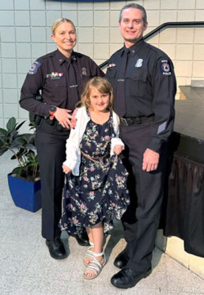  Officer Hailey Penzak and Detective Shawn Penzak, of the Novi Police Department, pose for a photo with their 7-year-old daughter, Avery. 