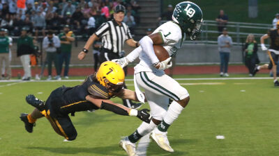  Lake Orion senior Raymond Payne sheds a Rochester Adams tackler during Lake Orion's 35-0 win over Adams on Sept. 29 at Adams High School. 
