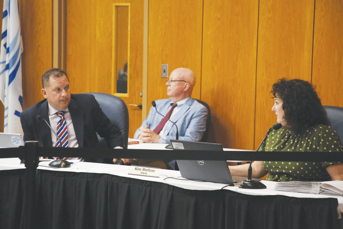  Clinton Township Clerk Kim Meltzer, right, explains the necessity of election worker and equipment tracking software to Township Treasurer Paul Gieleghem.  
