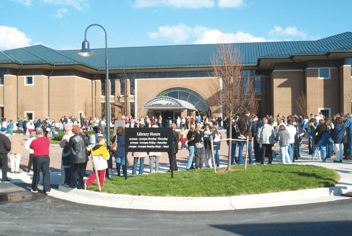  A crowd waits to get into the Clinton-Macomb Public Library’s Main Library on opening day, Oct. 26, 2003. 