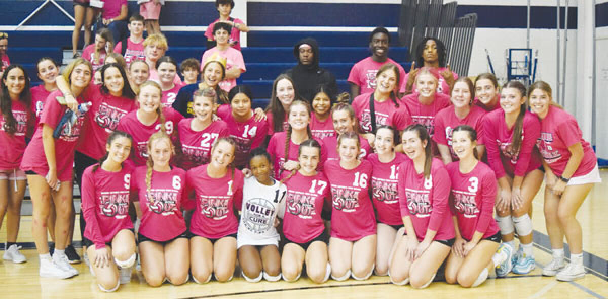  The Royal Oak Shrine Catholic varsity and junior varsity volleyball teams take a picture to celebrate the school’s annual Pink Out game Oct. 3 at Shrine Fieldhouse. 