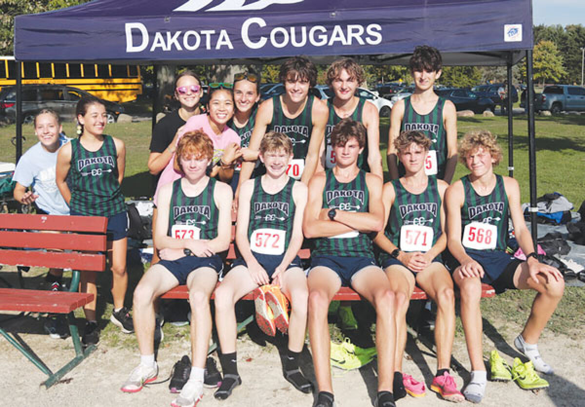  Macomb Dakota boys cross-country takes a group photo with some of the girls team members. 