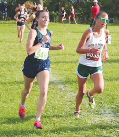  Macomb Dakota sophomore Lidia Clancy smiles during her run at the Jackson Invitational at Ella Sharp Park in Jackson on Sept. 23. 