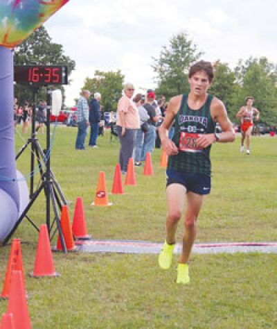  Macomb Dakota senior Simon Davis crosses the finish line at the MAC Red Jamboree at Stony Creek Metropark on Sept. 12, finishing in sixth. 