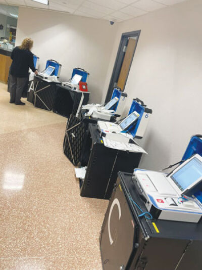  Troy Clerk Aileen Dickson runs tests on ballot tabulators in preparation for early voting, which will now be offered at the Troy Community Center nine days before elections. 