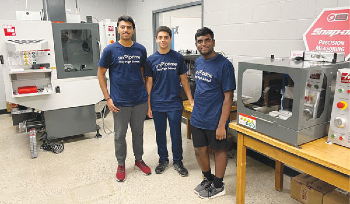  On Oct. 6, Troy High School cut the ribbon on its new manufacturing lab, acquired thanks to a partnership with the SME Foundation. Pictured, students Nivin Suresh, a sophomore, Yousef Yassa, a junior, and Karthik Prasant, a sophomore, stand next to some of the equipment. 