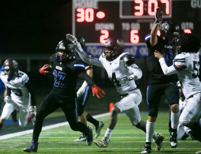  Royal Oak senior Jagger Acosta carries the ball during Royal Oak’s 37-0 win over Berkley. 