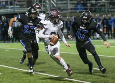  Royal Oak defenders swarm Berkley quarterback Sunny Kadlitz.  