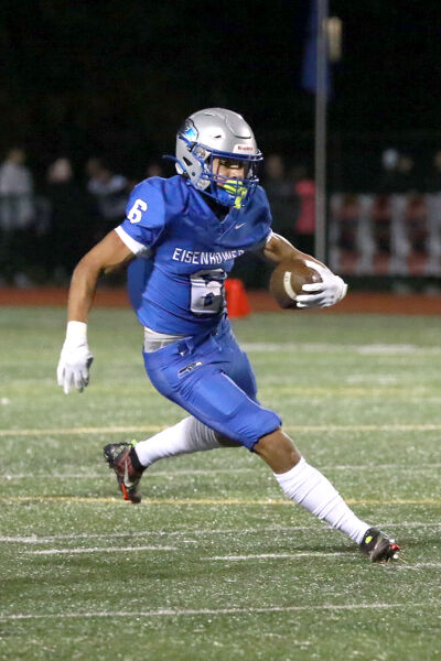  Utica Eisenhower junior Bryce Hurley carries the ball against Utica on Oct. 13 at Swinehart Stadium. 