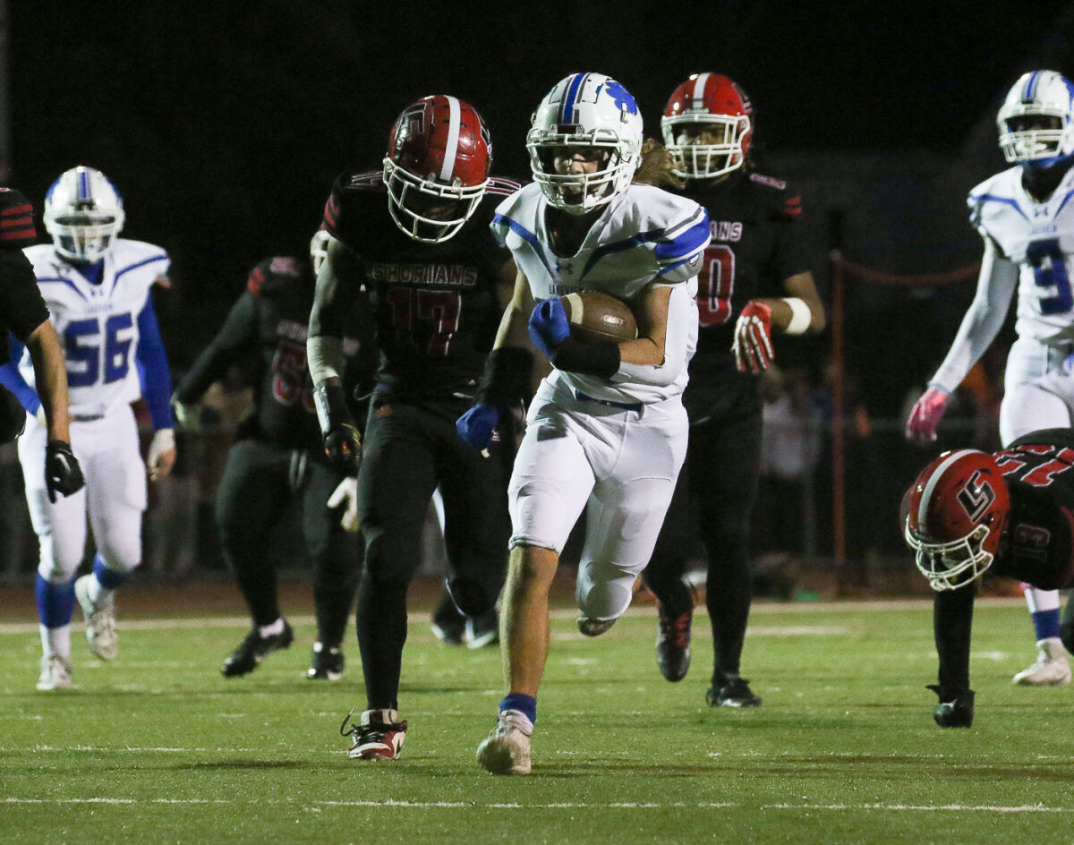  Lakeview senior Tucker Weddle carries the ball against Lake Shore on Oct. 13. Weddle ran for 75 yards on 11 carries.  