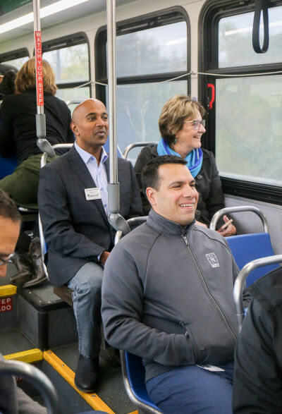  Oakland County Commissioners Ajay Raman and Gwen Markham and Novi City Manager Victor Cardenas enjoy some conversation during the bus ride on the newly expanded 740 SMART route. 