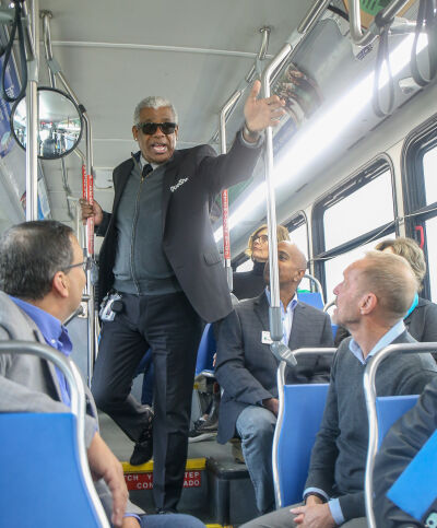  SMART General Manager Dwight Ferrell speaks to the media and dignitaries onboard the newly expanded 740 bus, which runs across 12 Mile Road into Novi. 