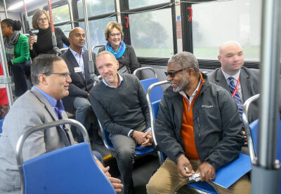  Oakland County officials, representatives from the Suburban Mobility Authority for Regional Transportation and members of the media take a ride Oct. 17 on the newly expanded route 740, which travels across 12 Mile Road into Novi. Pictured from back left are Tiffany Gunter, deputy manager and chief operating officer of SMART, Amy LeFebre, of Truscott Rossman Group, David Woodward, chairman of the Oakland County Board of Commissioners; Commissioner Ajay Raman; Oakland County Executive Dave Coulter; Commissioner Gwen Markham; Bernard Parker III, SMART vice president of external affairs; and Daniel Whitehouse, vice president of paratransit and on demand services (Flex/rideshare) of SMART. 